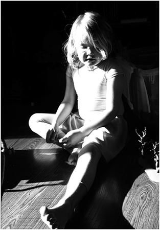 Portrait of young girl with strong shadow.